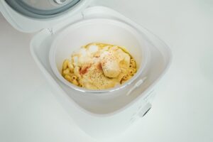 adding ingredients into rice cooker