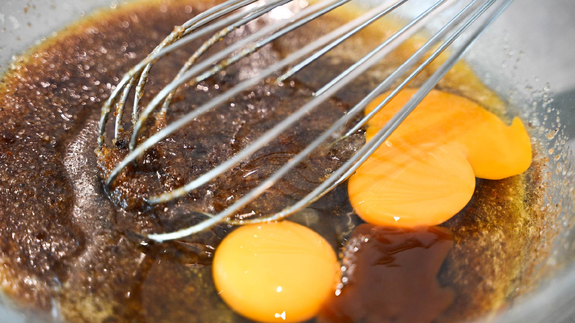 adding in eggs and vanilla essence